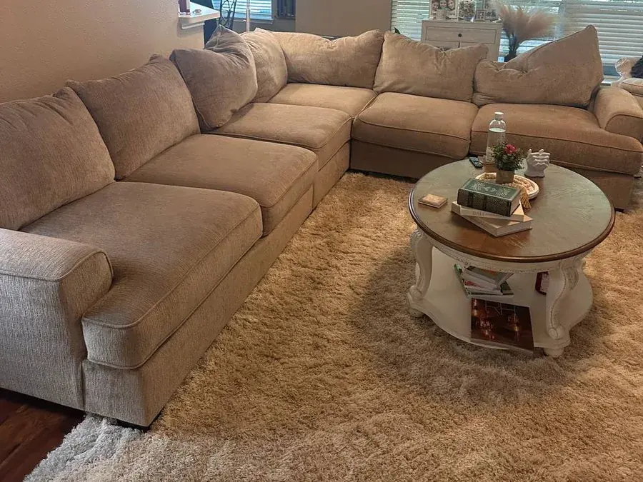 Large beige chenille sectional before cleaning, with pet hair and soil, in a Houston living room
