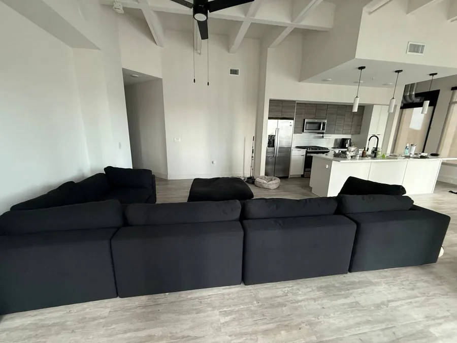 The same black sectional after cleaning, deep black again with no lint