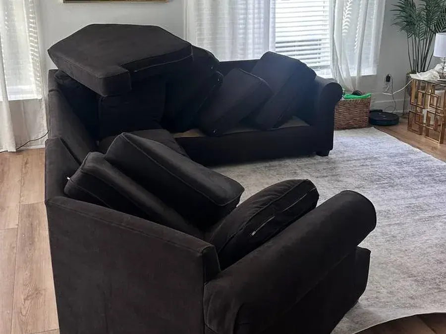 The same dark brown sectional after cleaning, cushions propped up to dry