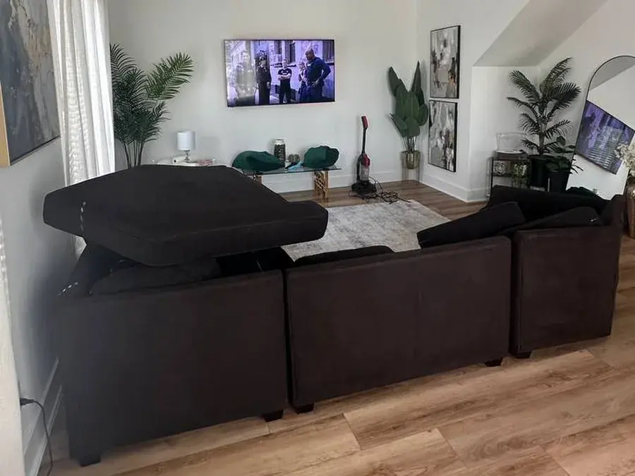 The dark brown sectional after cleaning, seen from behind with cushions set up to dry