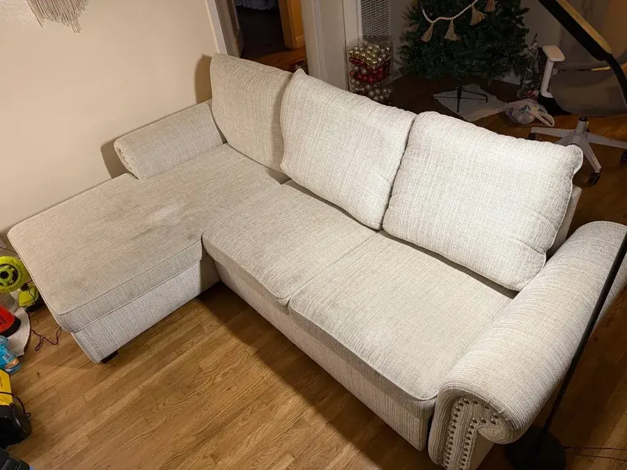 Light textured sofa with chaise before cleaning, gray soil and food and drink stains on the chaise and seats, in a Houston home