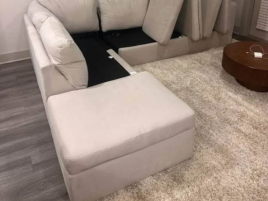 The same cream sectional after cleaning, cushions lifted to dry and the inside cleared of debris