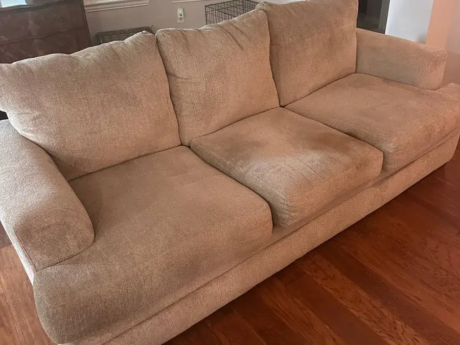 Beige chenille sofa before cleaning, with a large dog urine stain on the middle seat cushion