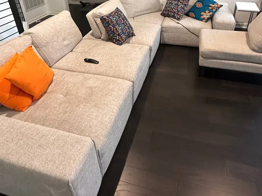 Light gray modular sectional with dirt, food and drink stains before cleaning in a Houston home