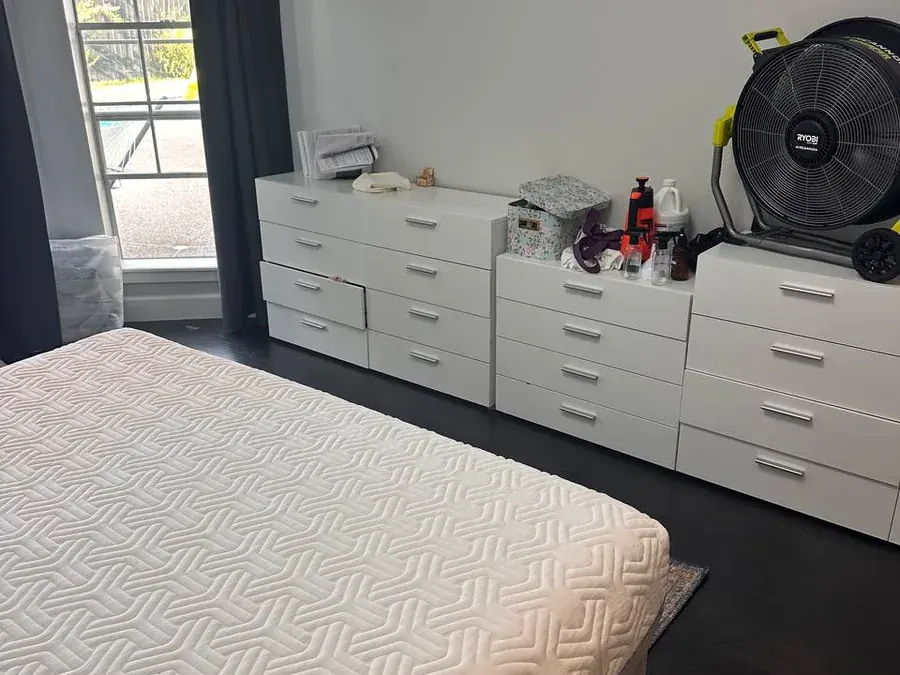 The same mattress drying after cleaning, with a large fan set up on the dresser