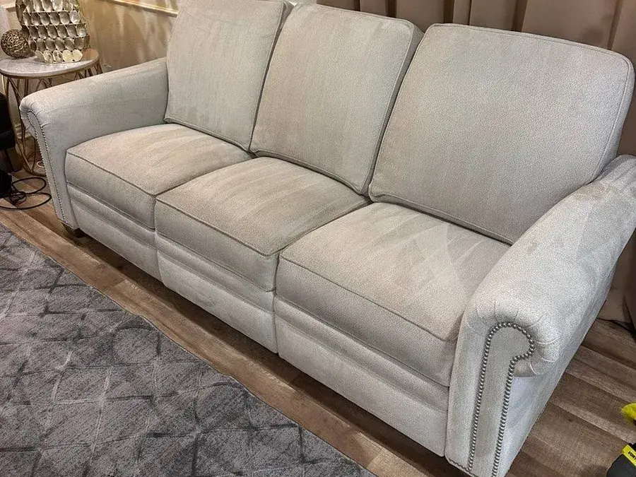 The same reclining sofa after cleaning, seats even and the grease stain removed