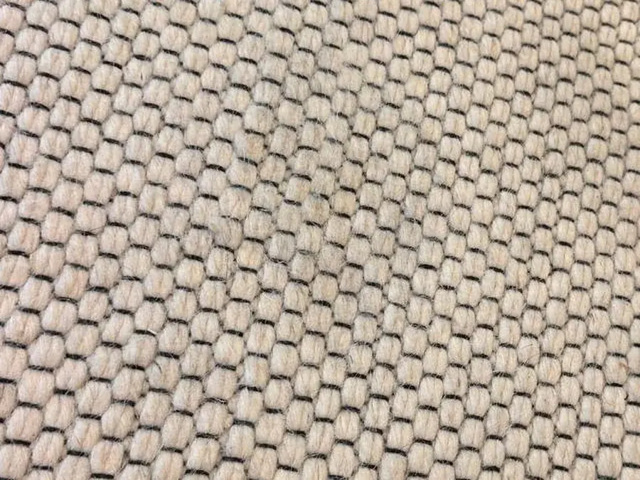 The same woven rug after rust stain removal, no trace of the stain