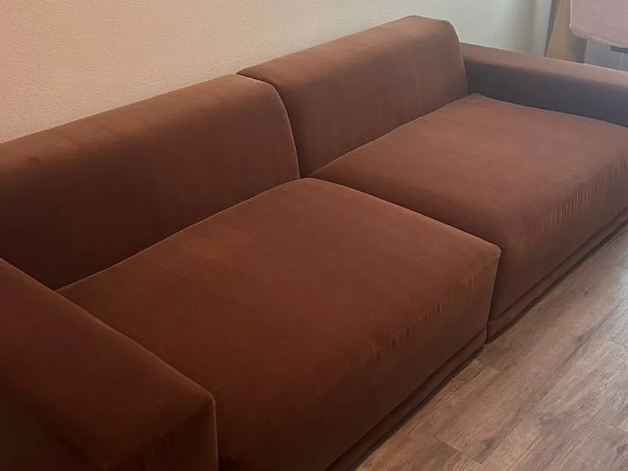 The rust sofa after cleaning, with a deeper, even color and no pet hair