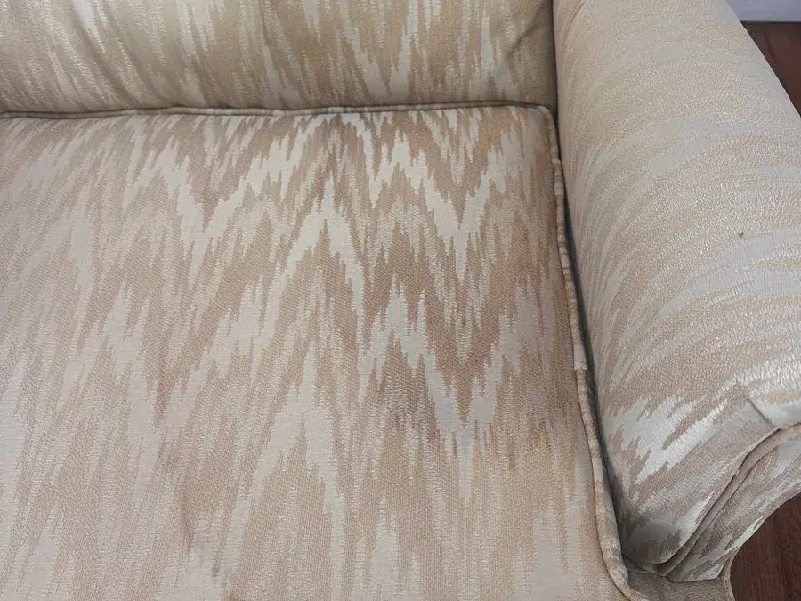 Dirty water rings across the seat of the wingback chair before cleaning