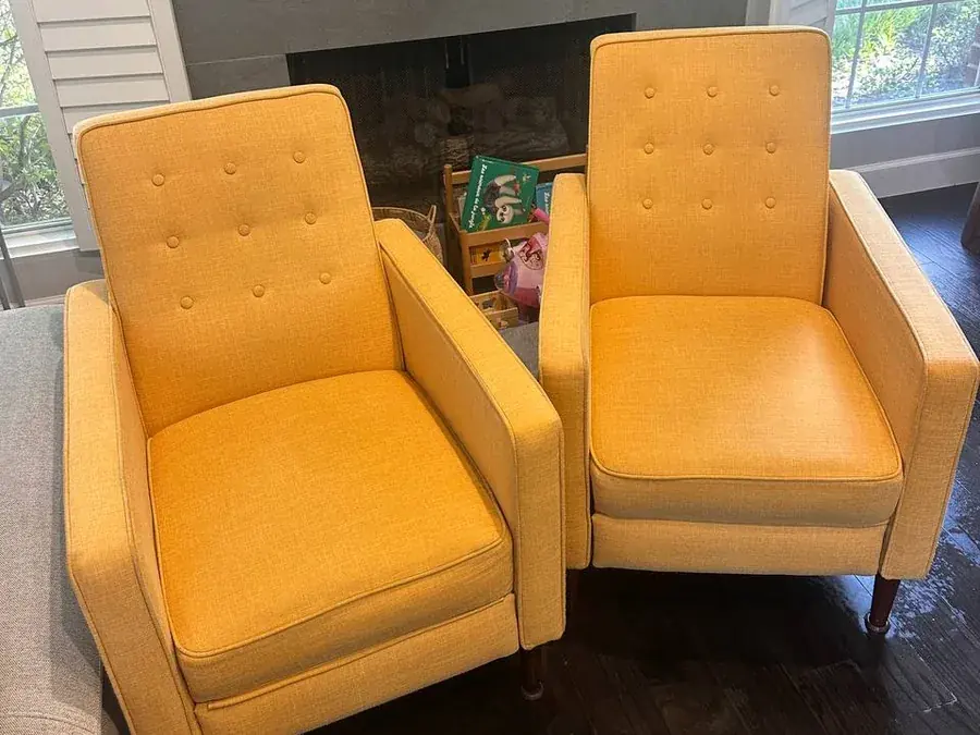 The same pair of yellow armchairs after upholstery cleaning, stains removed